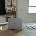 a laptop computer sitting on top of a wooden table