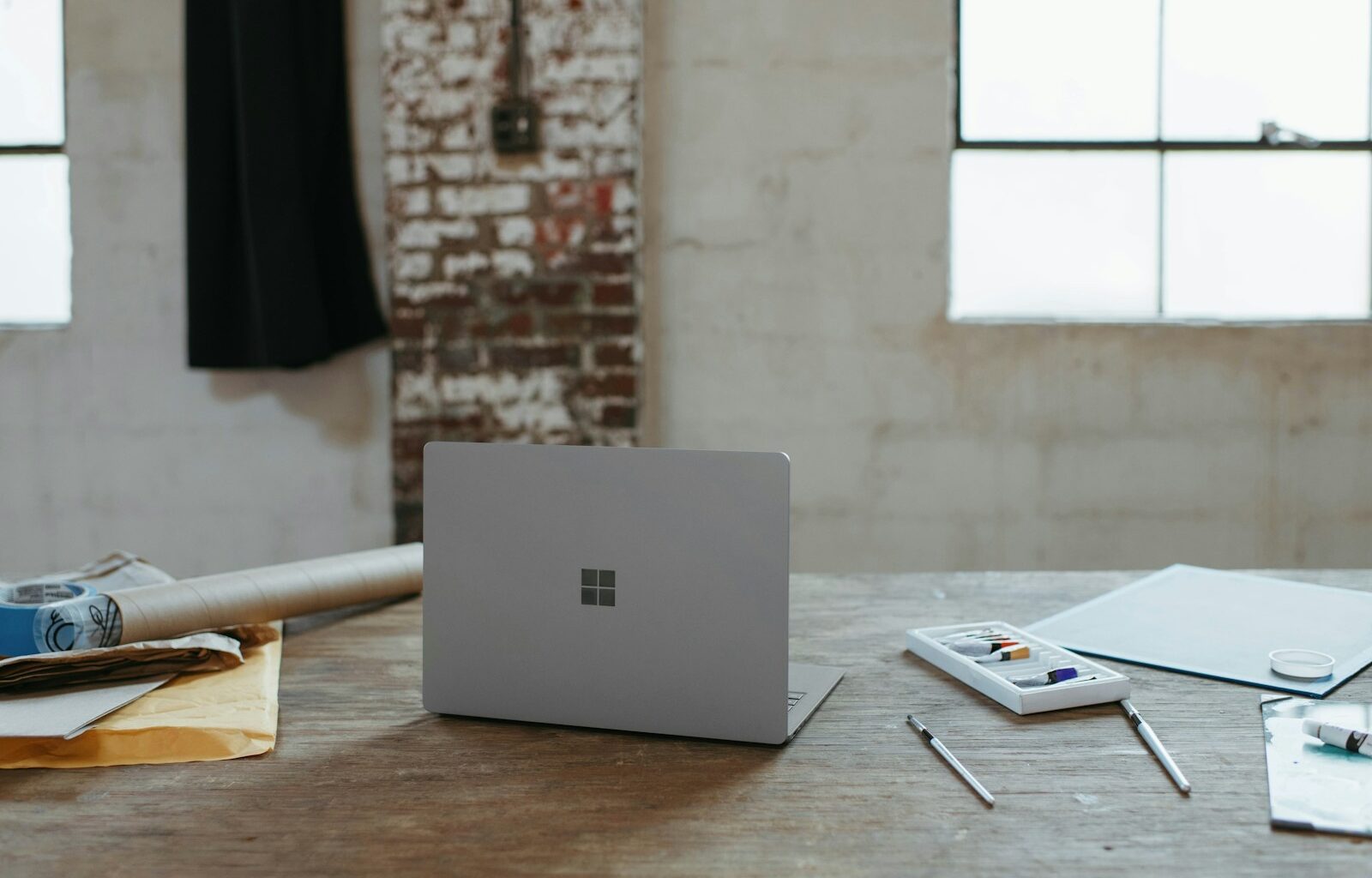 a laptop computer sitting on top of a wooden table