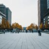 people walking on sidewalk near high rise buildings during daytime