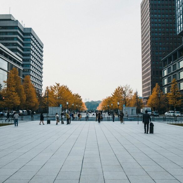 people walking on sidewalk near high rise buildings during daytime